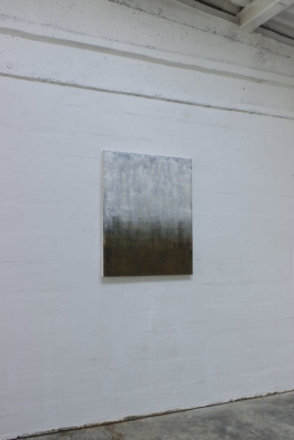 Contemporary abstract painting by Maria Paola Coda, featuring white and grey tones in the upper area and dark greens, blacks, and browns in the lower section. 